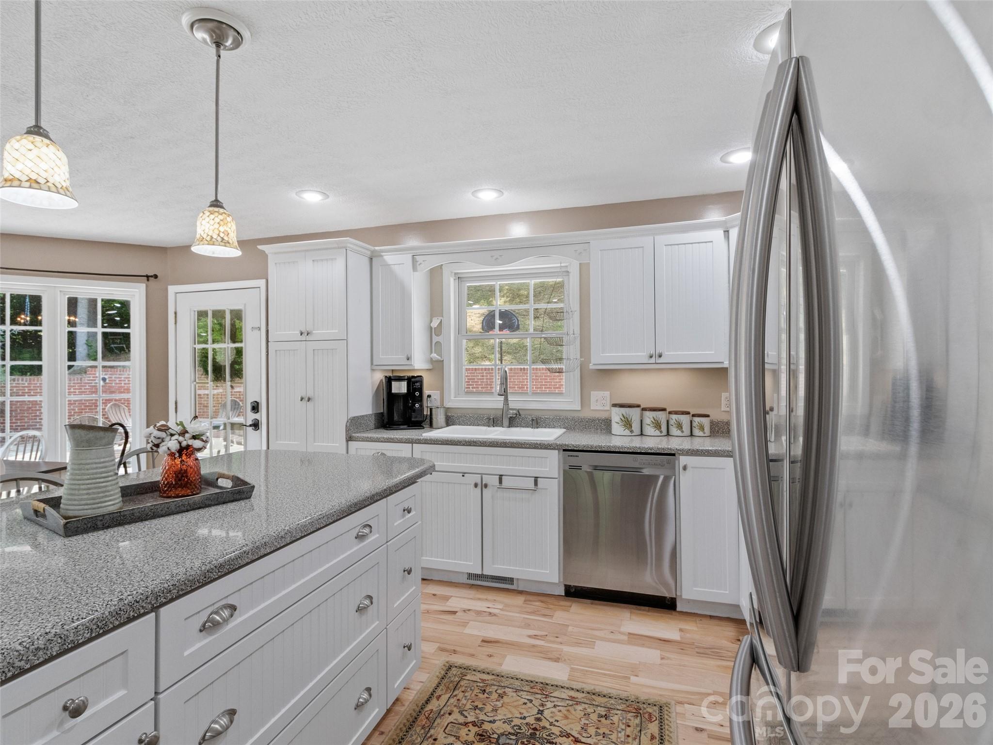 189 Poverty Branch Road Barnardsville, NC 28709 - Photo 14 of 48 a kitchen with stainless steel appliances granite countertop a refrigerator a sink a stove and white cabinets
