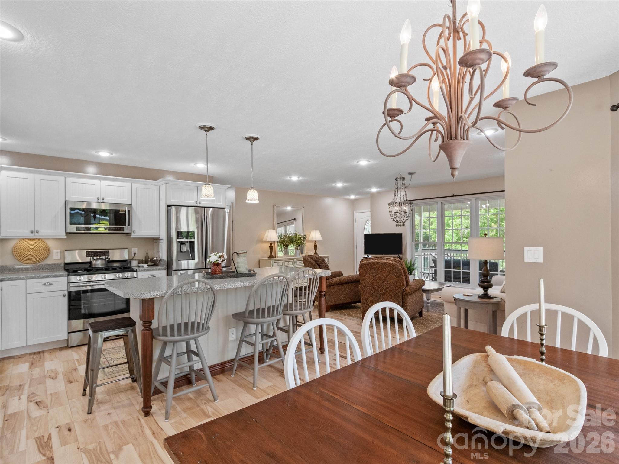 189 Poverty Branch Road Barnardsville, NC 28709 - Photo 15 of 48 a view of a dining room with furniture a kitchen and chandelier