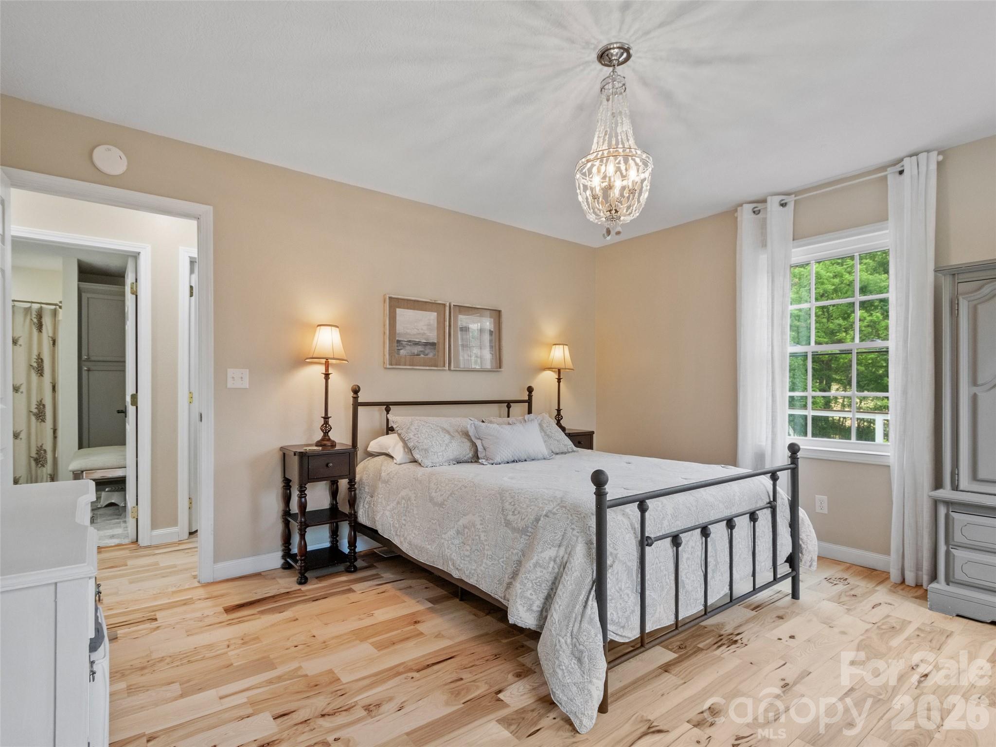 189 Poverty Branch Road Barnardsville, NC 28709 - Photo 19 of 48 a bedroom with a bed and a table in it