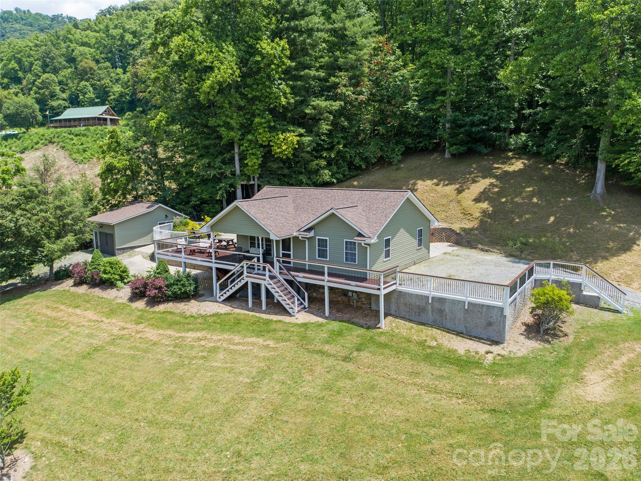 189 Poverty Branch Road Barnardsville, NC 28709 - Photo 2 of 48 a view of a house with pool and chairs