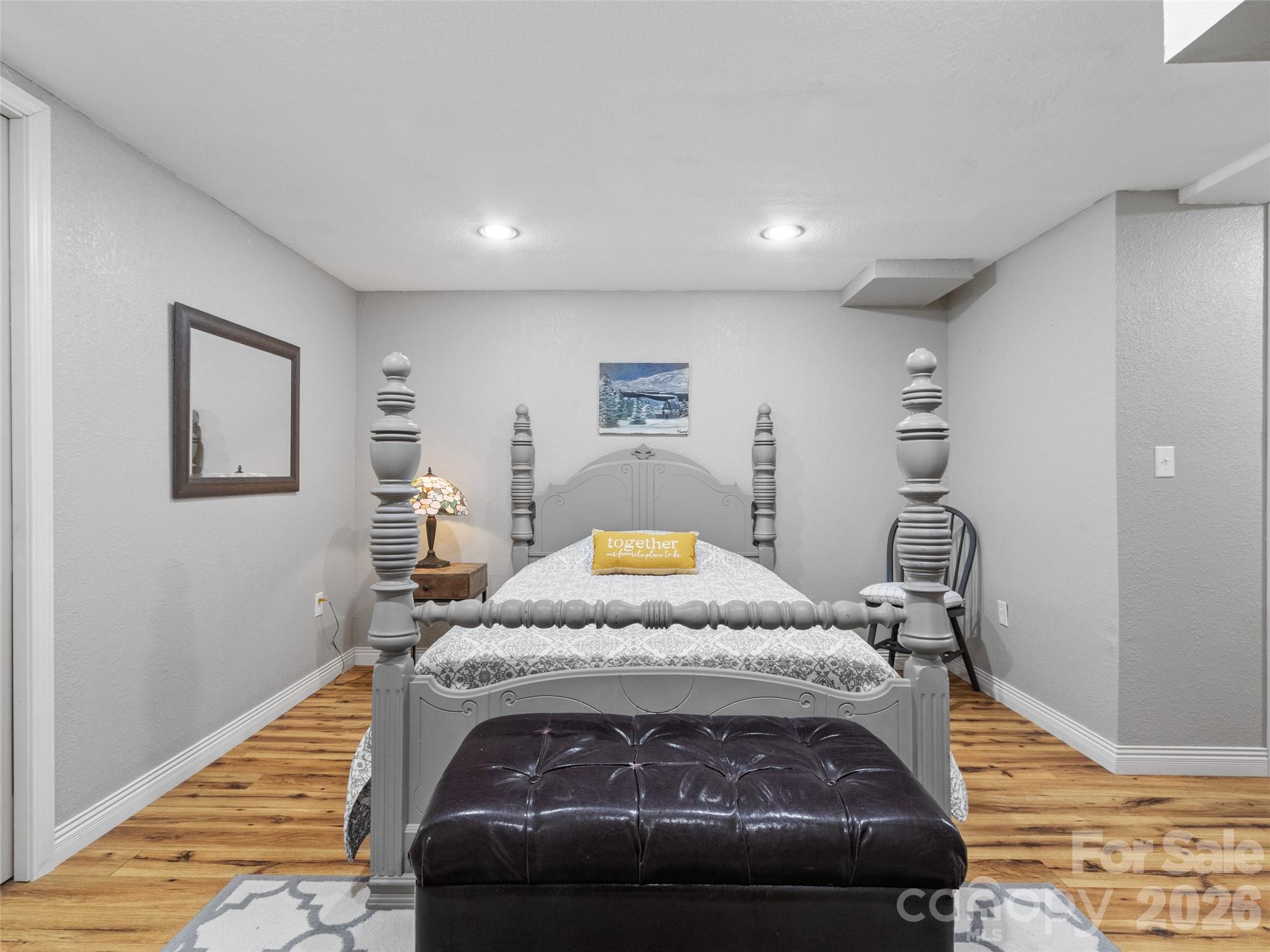 189 Poverty Branch Road Barnardsville, NC 28709 - Photo 29 of 48 a bedroom with a bed and wooden floor