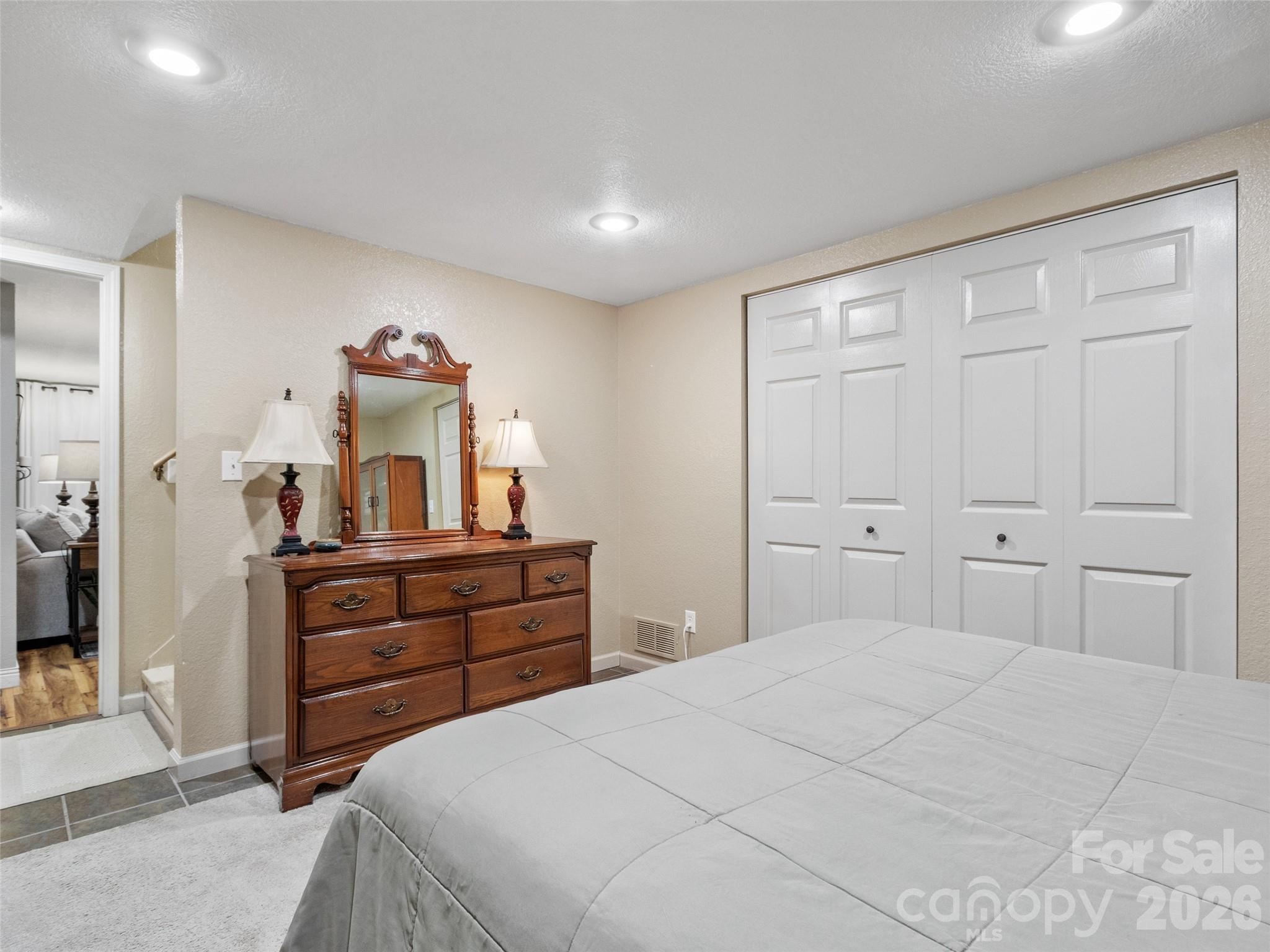 189 Poverty Branch Road Barnardsville, NC 28709 - Photo 34 of 48 a bedroom with a bed and a mirror