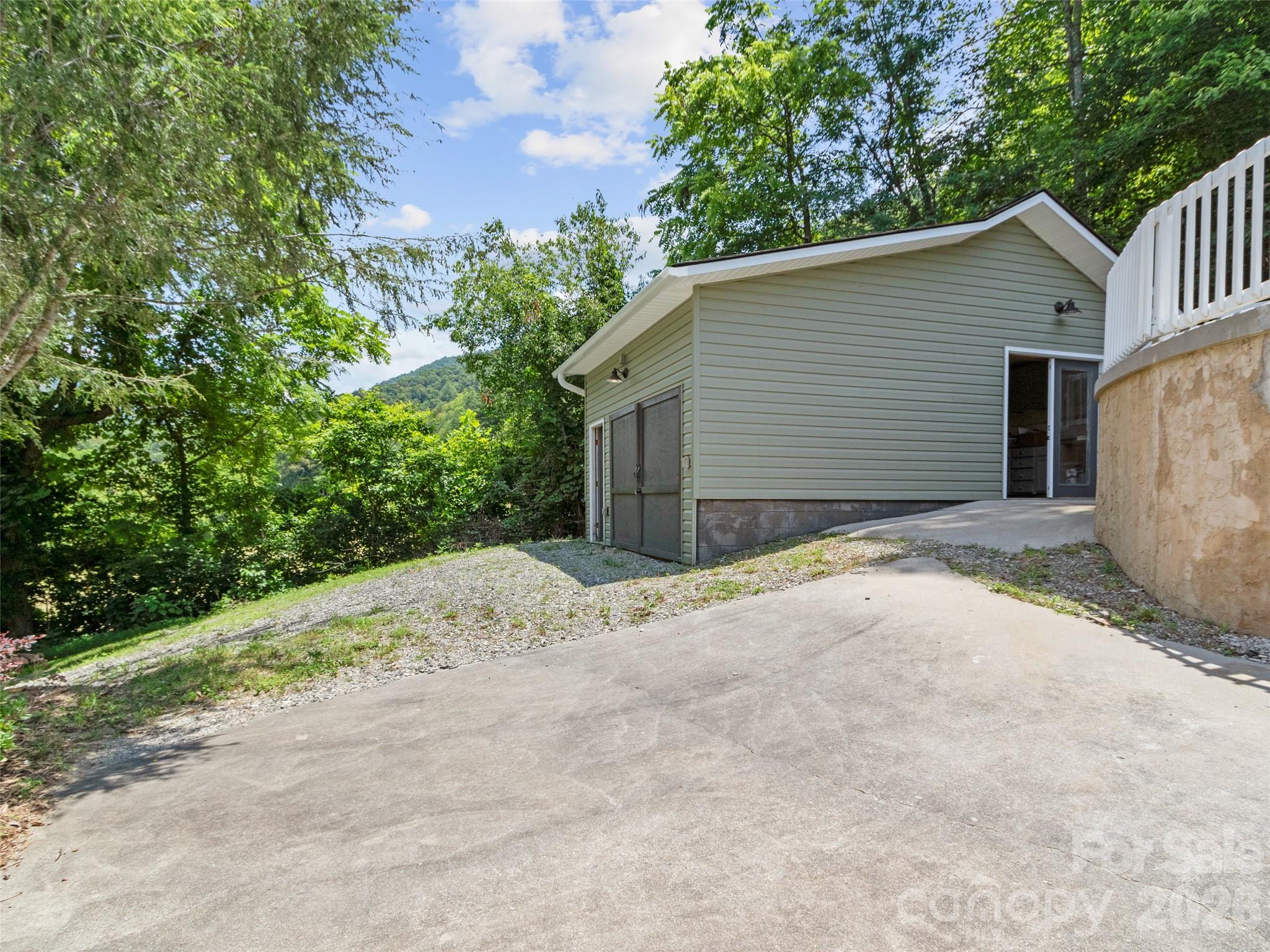189 Poverty Branch Road Barnardsville, NC 28709 - Photo 40 of 48 a view of a house with a yard and garage