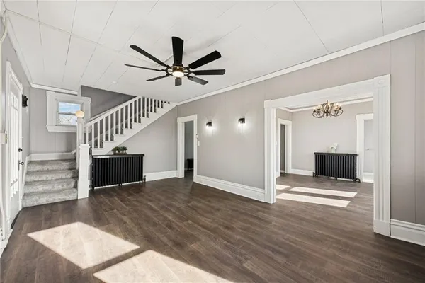 a view of entryway and hall with wooden floor
