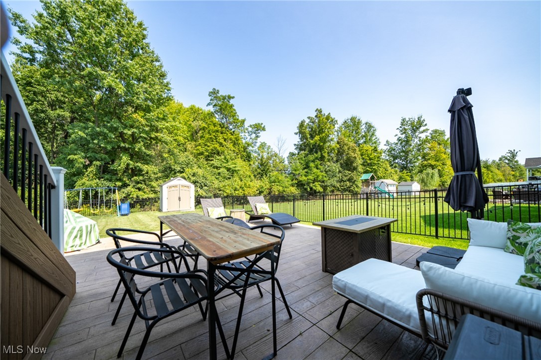 270 Stone Ridge Way Berea, OH 44017 - Photo 30 of 30 Wooden terrace with a storage unit, a yard, and outdoor lounge area