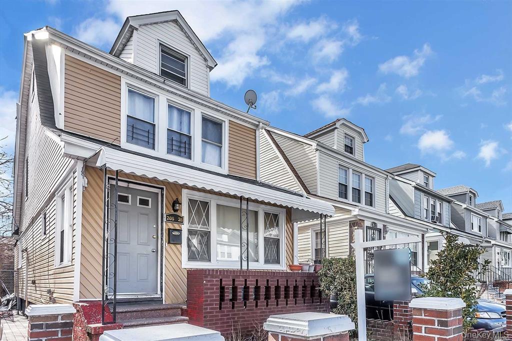 205-26 116th Road Queens, NY 11412 - Photo 1 of 2 a front view of a house with balcony