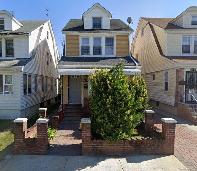 205-26 116th Road Queens, NY 11412 - Photo 2 of 2 a front view of a house with garden