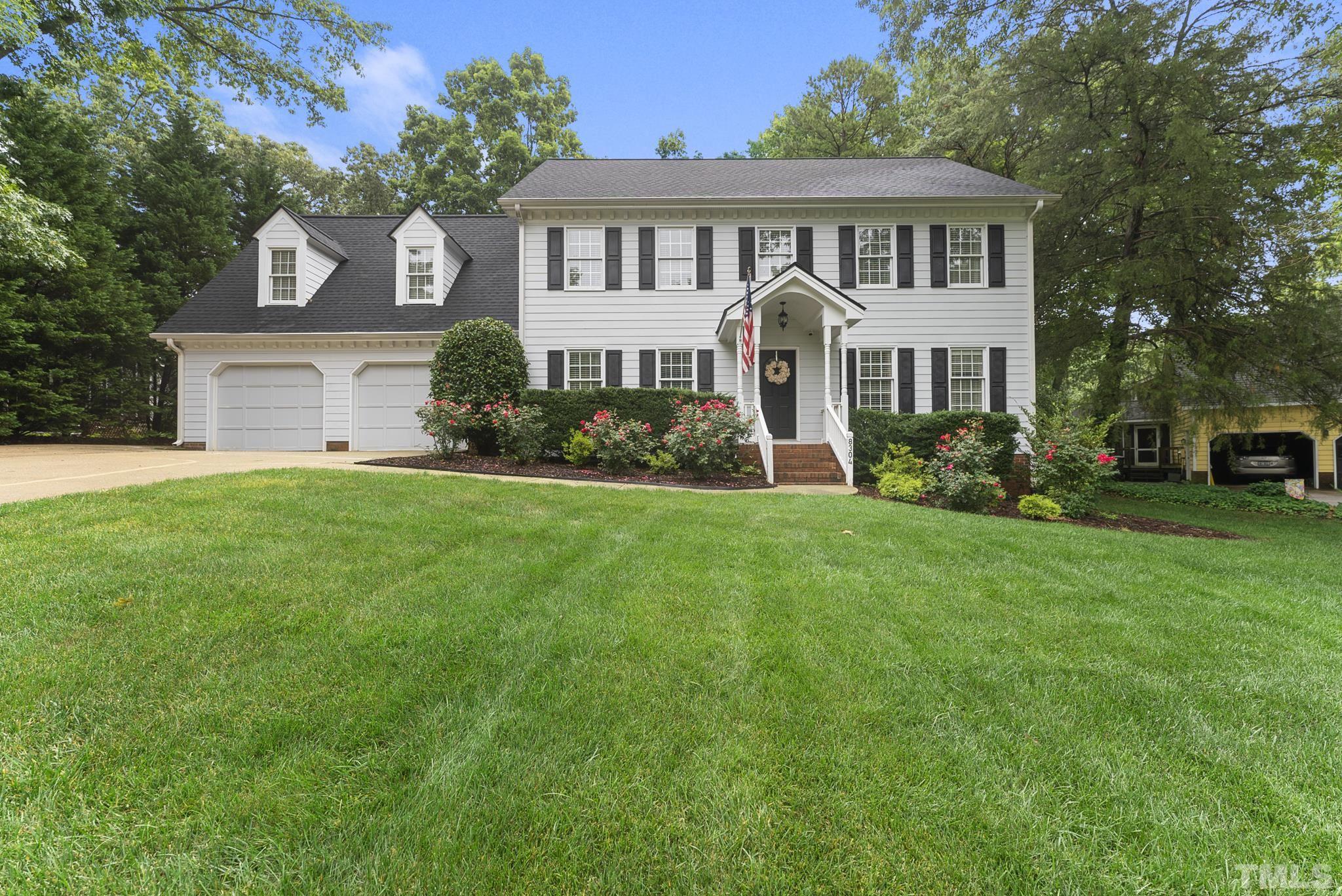 8304 Apple Orchard Way Raleigh, NC 27615 - Photo 1 of 36 a front view of a house with a garden and trees