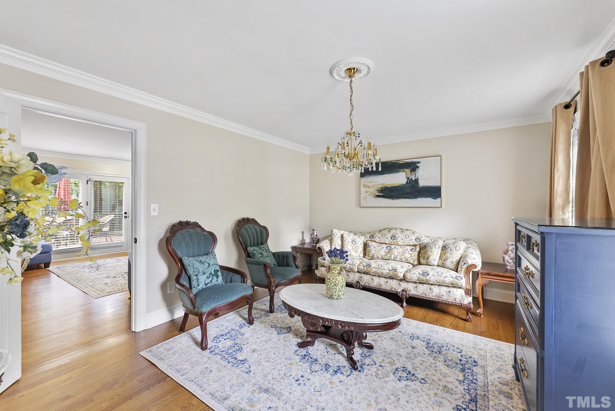 8304 Apple Orchard Way Raleigh, NC 27615 - Photo 3 of 36 a living room with furniture and a chandelier