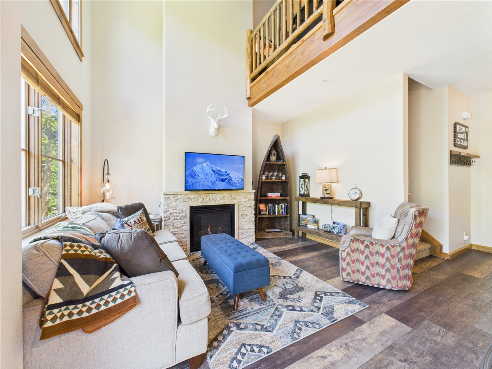 27 Lake Ridge Circle, Unit 1842 Keystone, CO 80435 - Photo 17 of 50 Inviting and open with two-story ceilings, gas fireplace, and loft overlook—perfect for cozy evenings or entertaining.