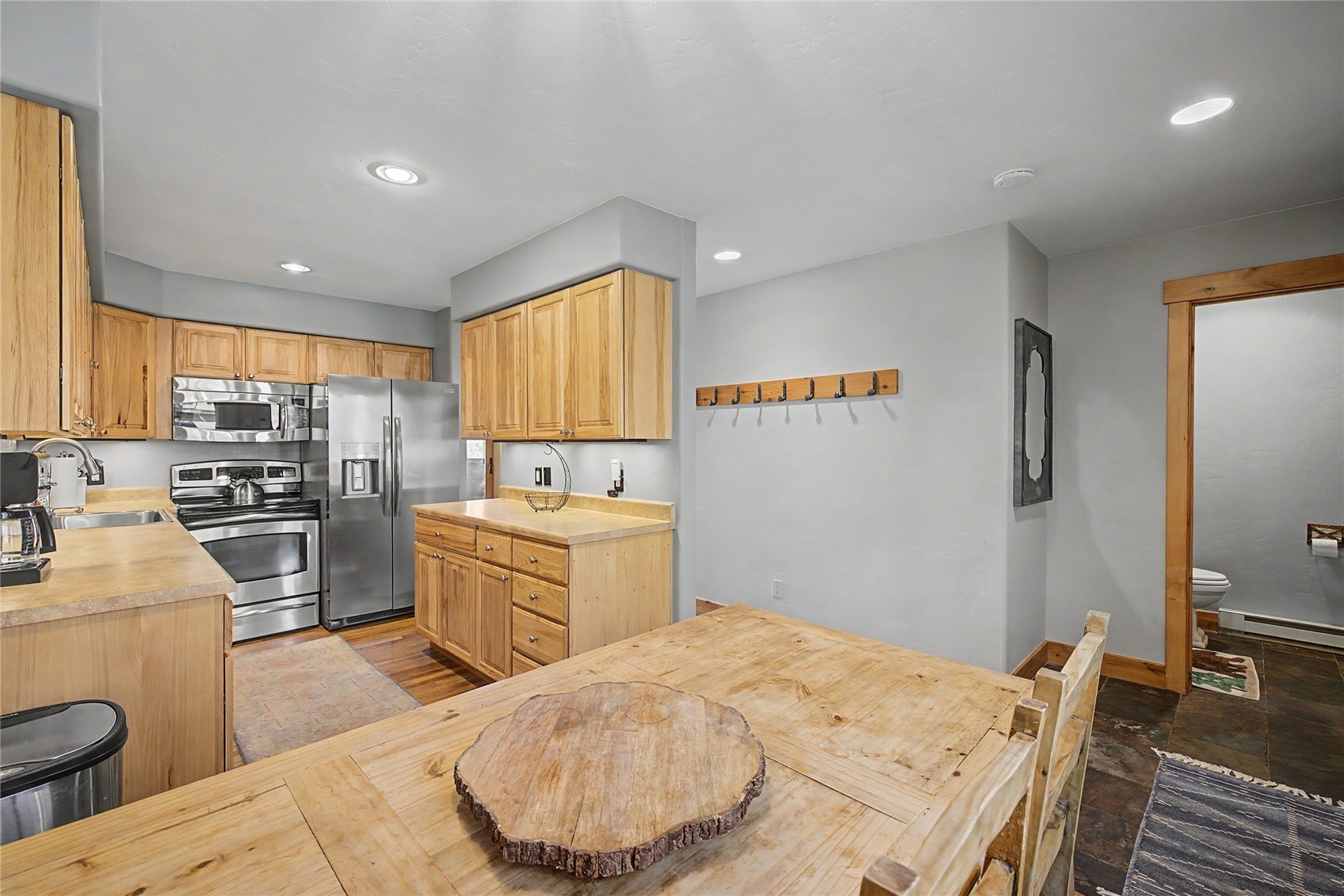 6726 Ryan Gulch Road, Unit 6726 Wildernest, CO 80498 - Photo 6 of 39 a kitchen with a stove a sink a refrigerator and a dining table