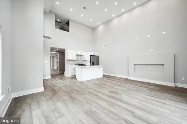 a view of a kitchen with furniture and wooden floor