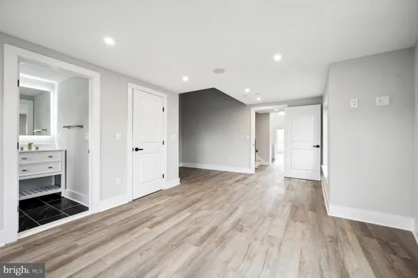 a view of a big room with wooden floor and bathroom