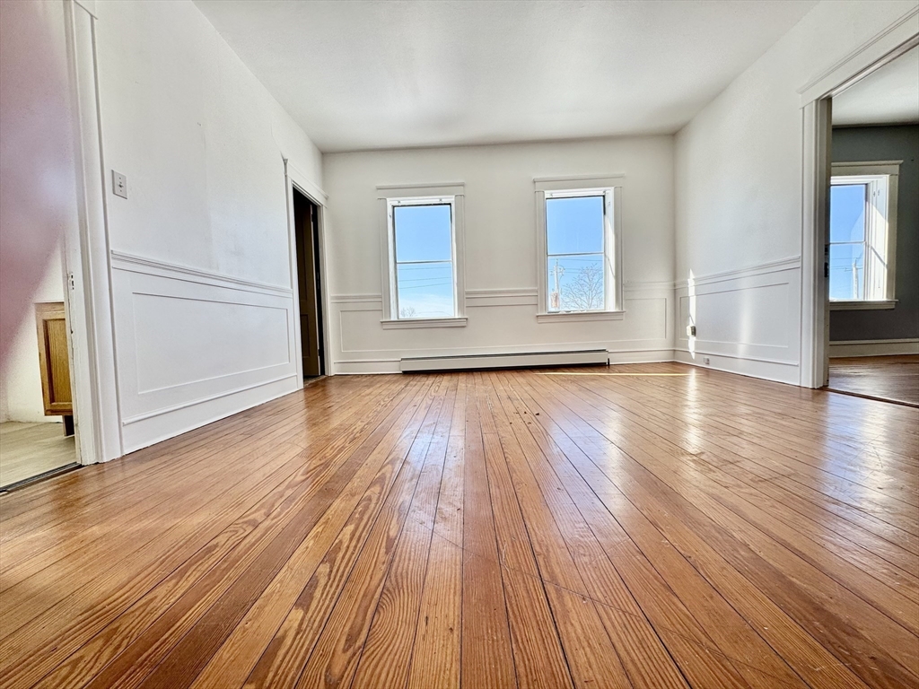 30 Broad Street Fall River, MA 02724 - Photo 16 of 31 an empty room with wooden floor and windows
