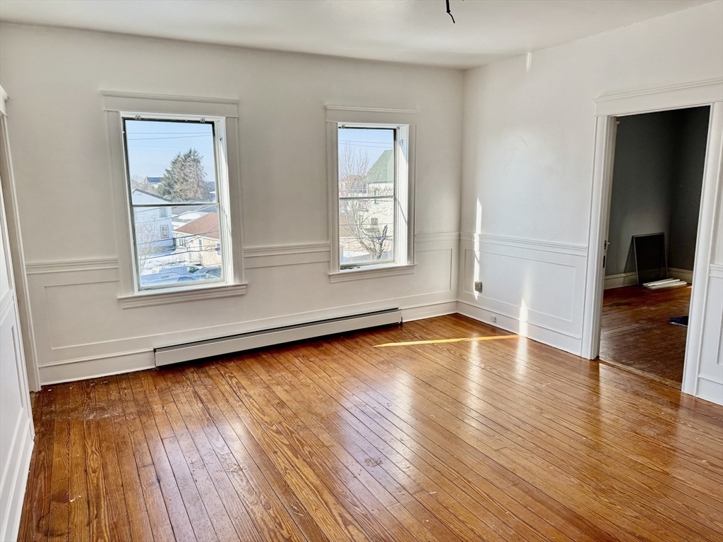 30 Broad Street Fall River, MA 02724 - Photo 19 of 31 a view of an empty room with wooden floor and a window