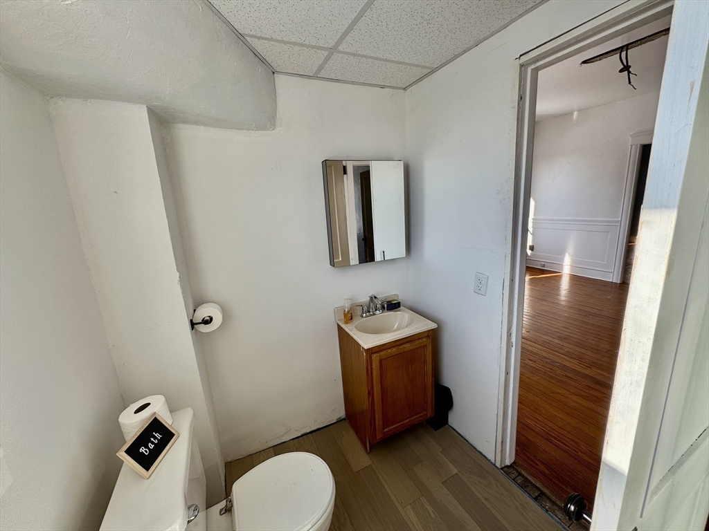 30 Broad Street Fall River, MA 02724 - Photo 24 of 31 a bathroom with a toilet a sink and mirror