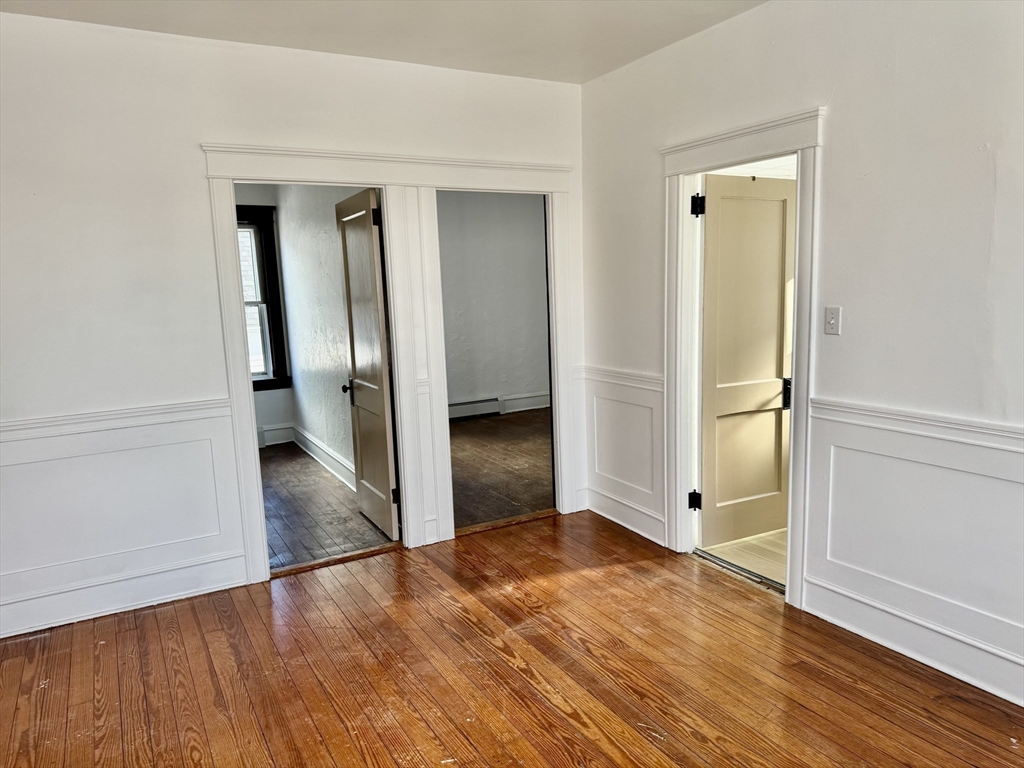 30 Broad Street Fall River, MA 02724 - Photo 25 of 31 an empty room with wooden floor and entrance