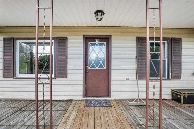 a view of a house with a door and wooden floor