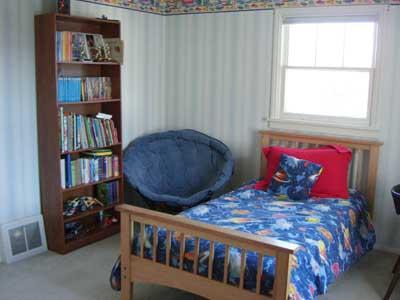 1080 Rosenkranz Road Tieton, WA 98947 - Photo 8 of 12 a bedroom with two large bed and a book shelf