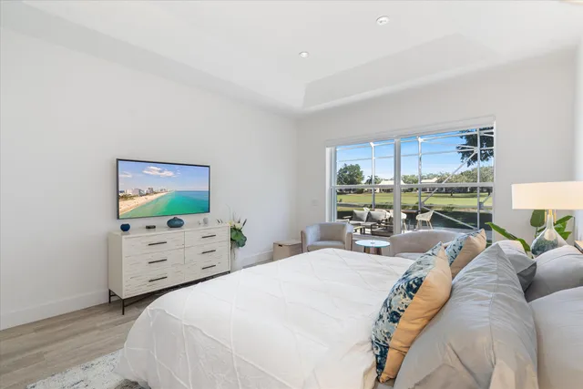 a bedroom with bed and a large window