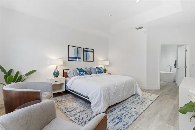 a bedroom with furniture and a large window