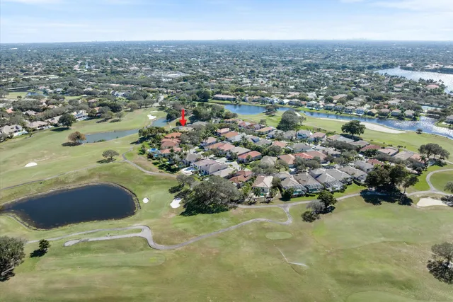 an aerial view of a house with a garden and trees