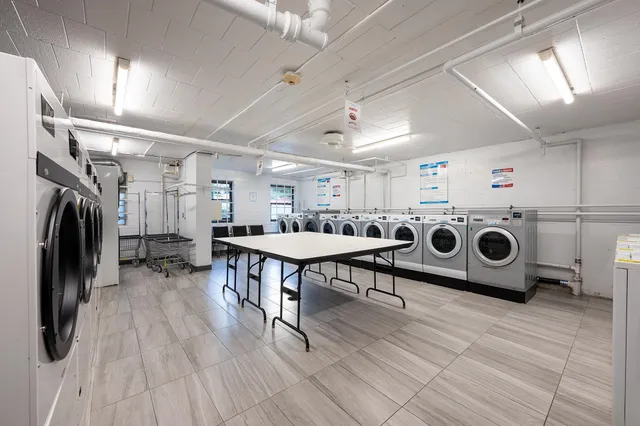 a utility room with a wooden floor a washer and dryer