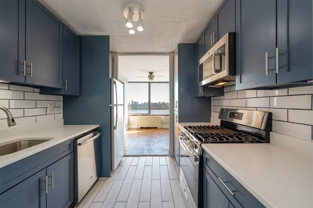 a kitchen with stainless steel appliances granite countertop a sink stove and cabinets