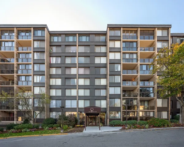 a front view of a building with a yard