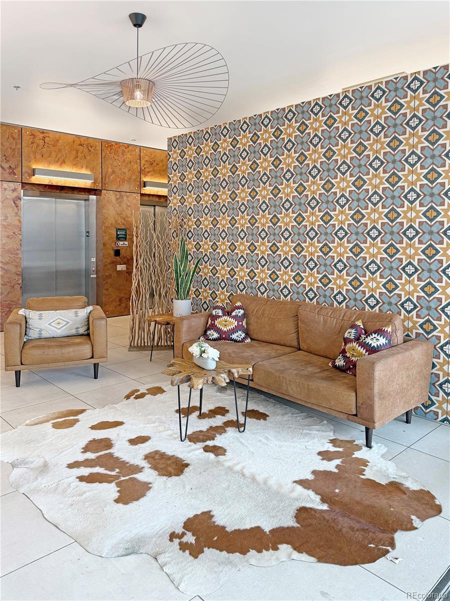 603 Inca Street, Unit 429 Denver, CO 80204 - Photo 13 of 16 a living room with furniture and a chandelier