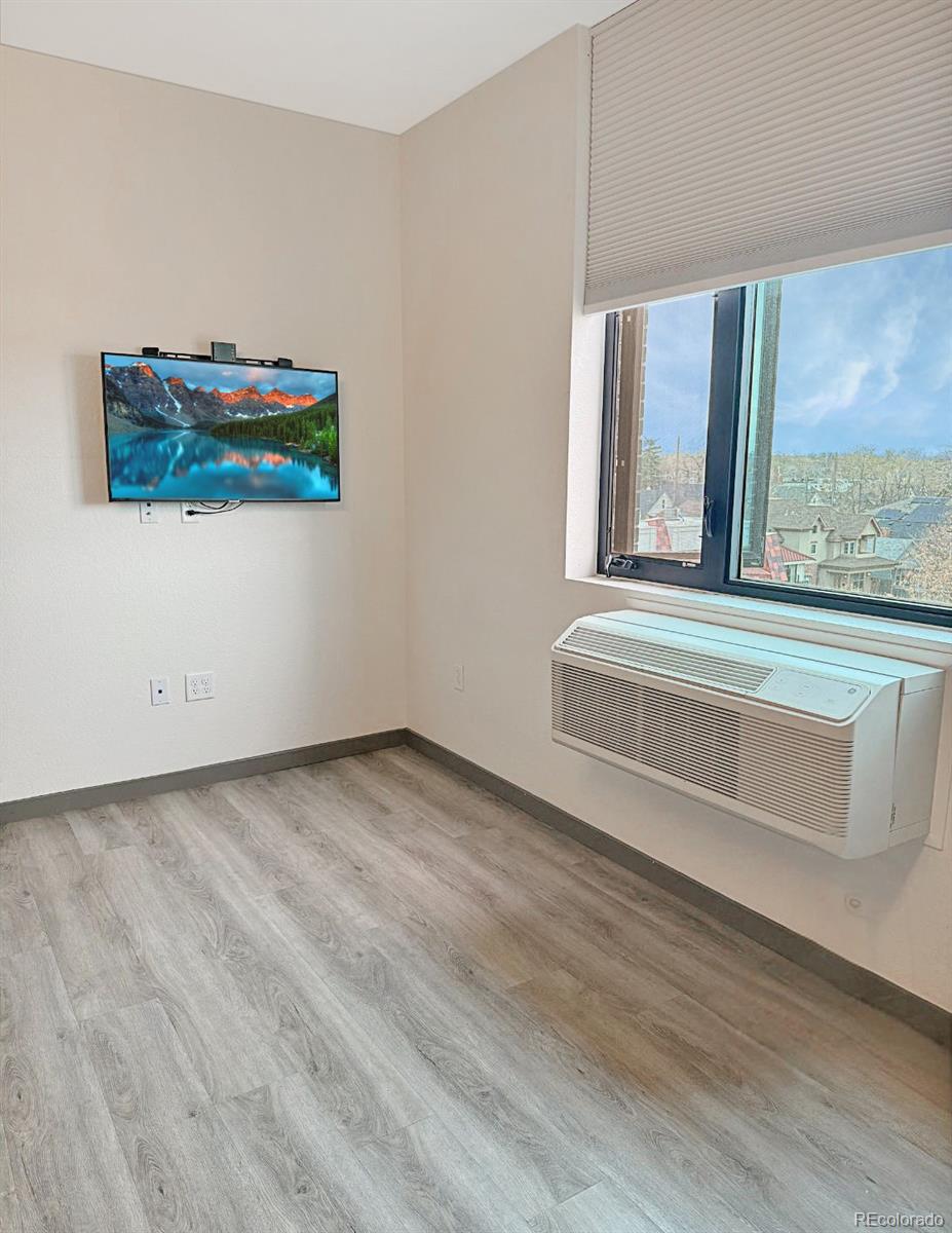 603 Inca Street, Unit 429 Denver, CO 80204 - Photo 3 of 16 a view of a livingroom with wooden floor and a large window