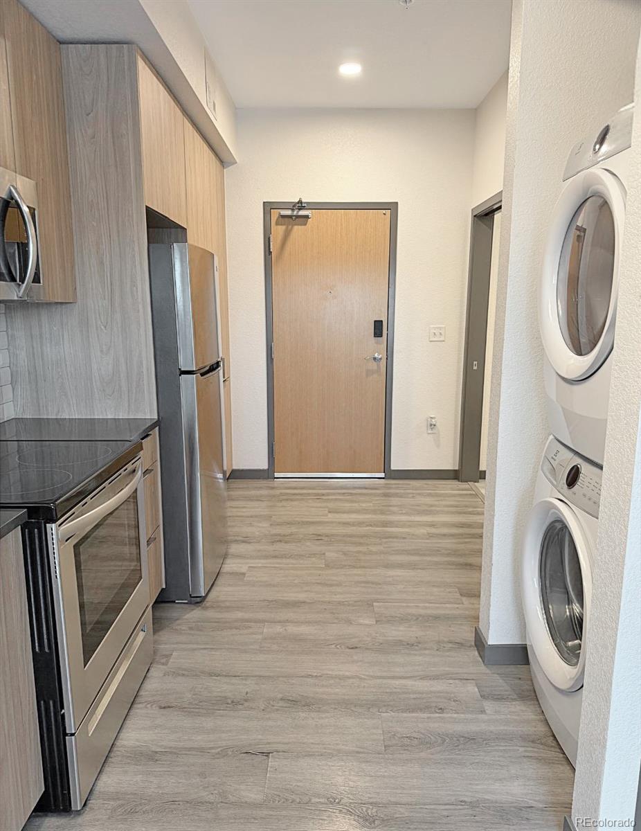 603 Inca Street, Unit 429 Denver, CO 80204 - Photo 5 of 16 a view of a storage and utility room with washer and dryer