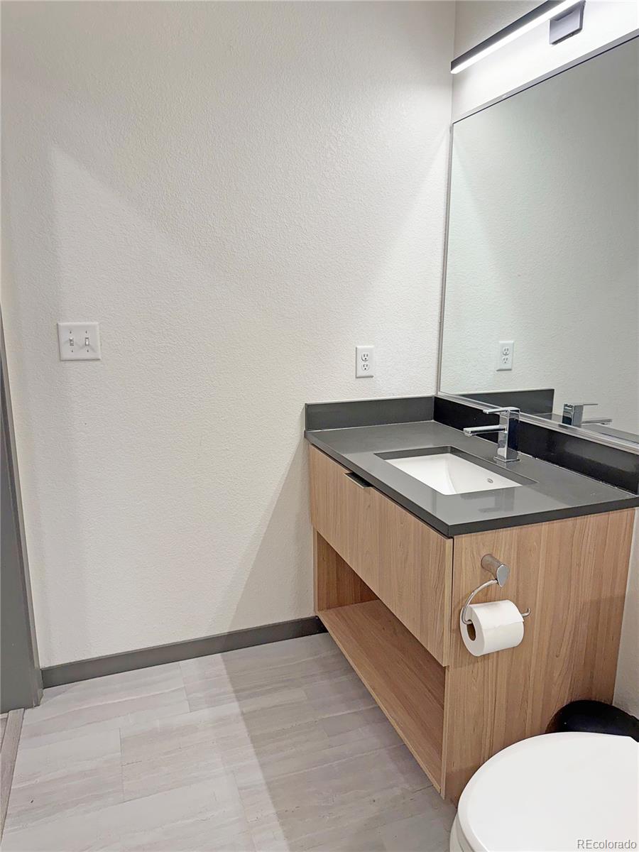 603 Inca Street, Unit 429 Denver, CO 80204 - Photo 9 of 16 a bathroom with a sink a toilet and mirror