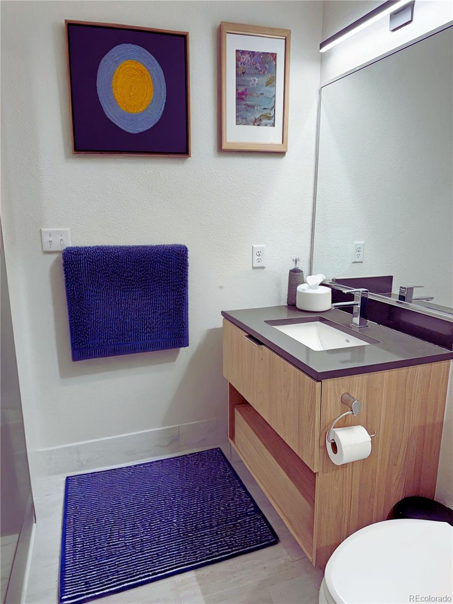 603 Inca Street, Unit 429 Denver, CO 80204 - Photo 10 of 16 a bathroom with a sink mirror vanity and toilet