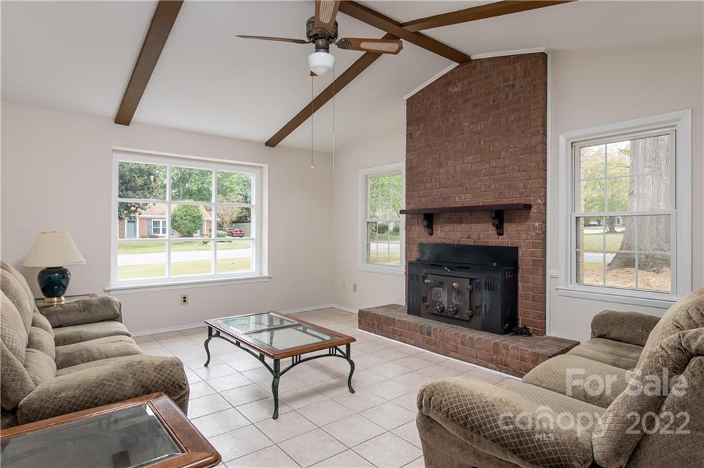 6777 Stoney Ridge Road Matthews, NC 28104 - Photo 13 of 27 a living room with furniture a window and a fireplace