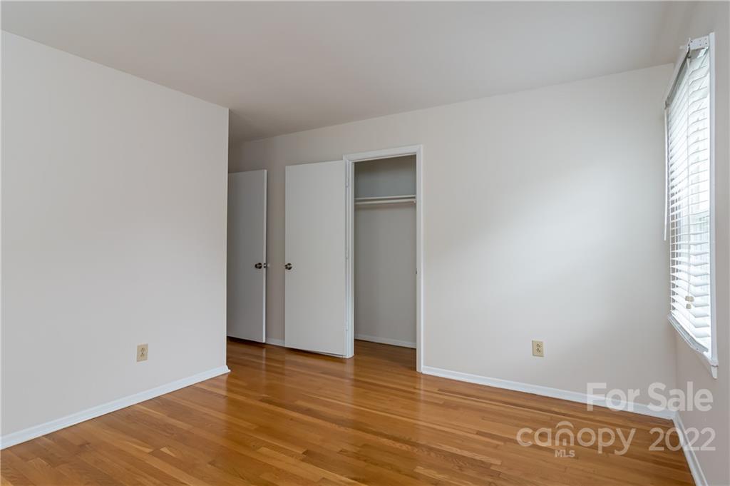 6777 Stoney Ridge Road Matthews, NC 28104 - Photo 21 of 27 an empty room with wooden floor and windows