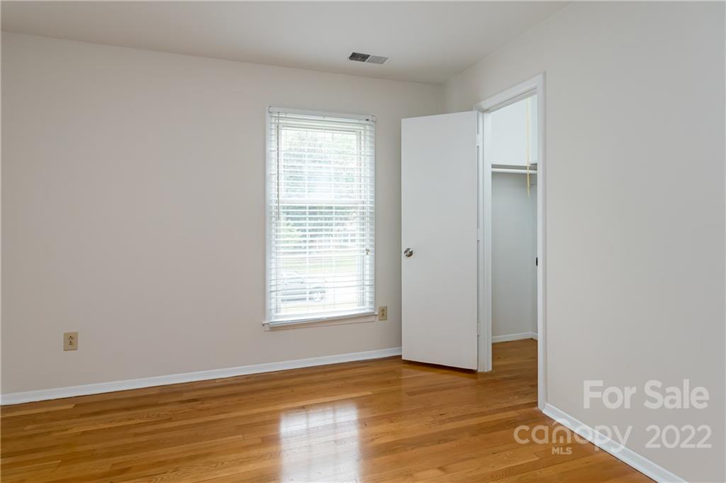 6777 Stoney Ridge Road Matthews, NC 28104 - Photo 22 of 27 an empty room with wooden floor and windows