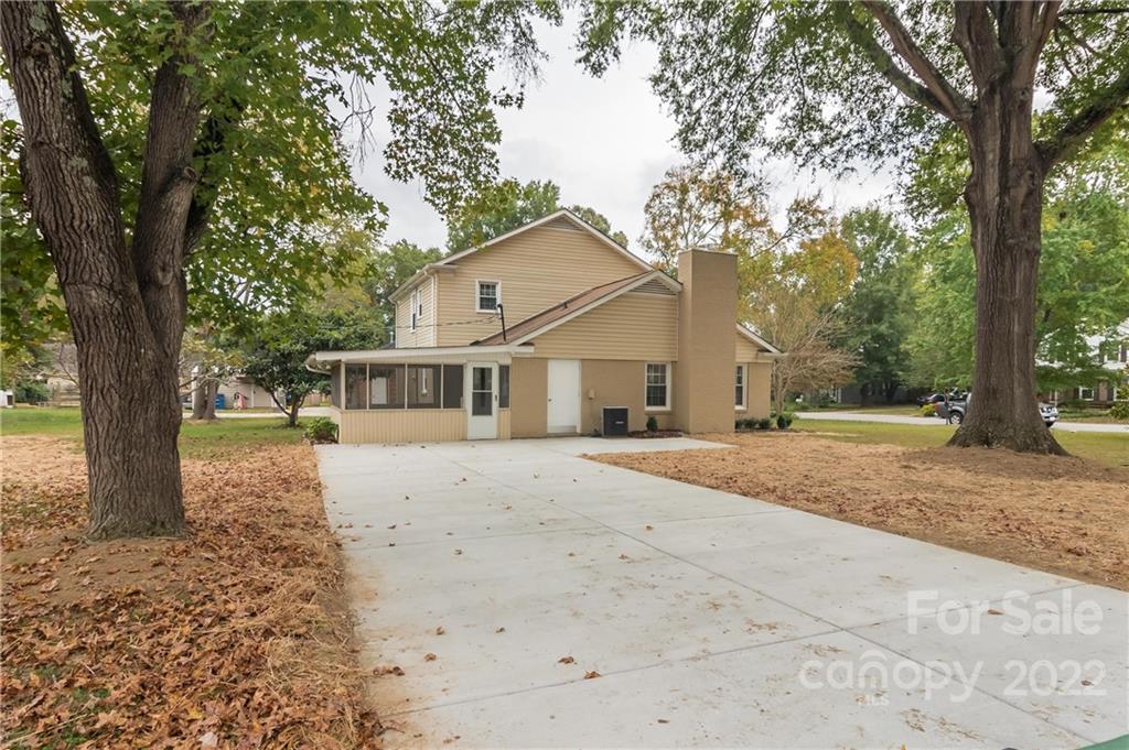 6777 Stoney Ridge Road Matthews, NC 28104 - Photo 27 of 27 a front view of a house with a dirt yard and a large tree