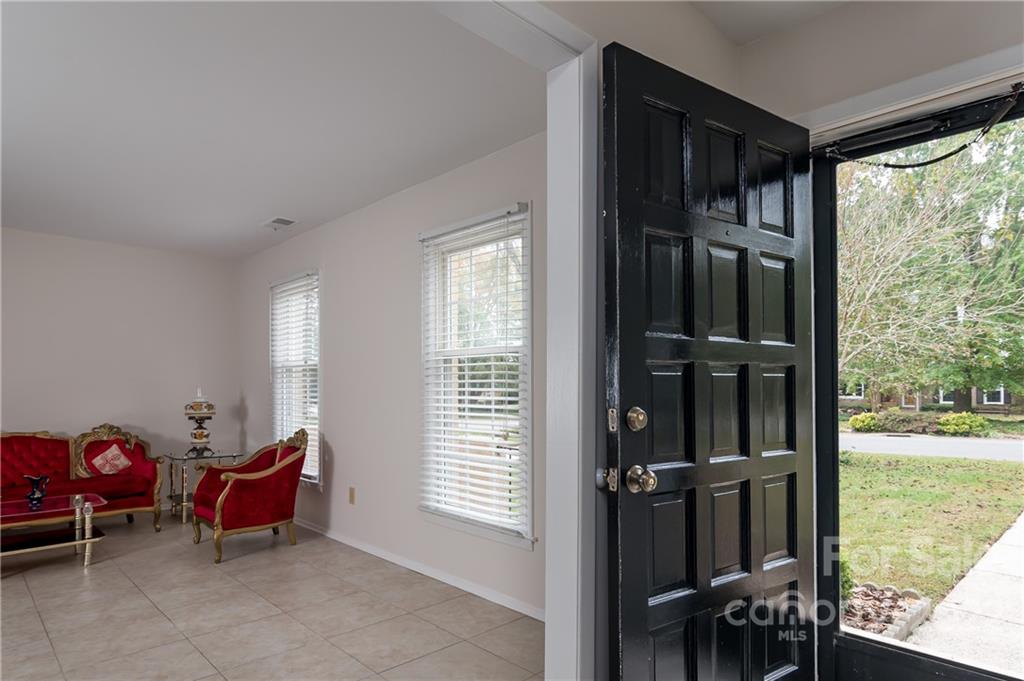 6777 Stoney Ridge Road Matthews, NC 28104 - Photo 4 of 27 a living room with furniture a window and a table