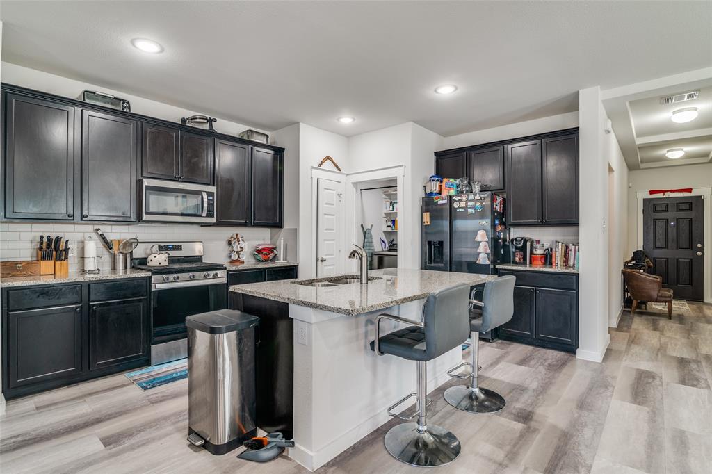 4204 Bullock Lane Forney, TX 75126 - Photo 11 of 25 a kitchen with sink cabinets and stainless steel appliances