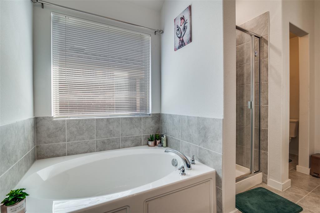 4204 Bullock Lane Forney, TX 75126 - Photo 16 of 25 a bathroom with a bathtub and shower