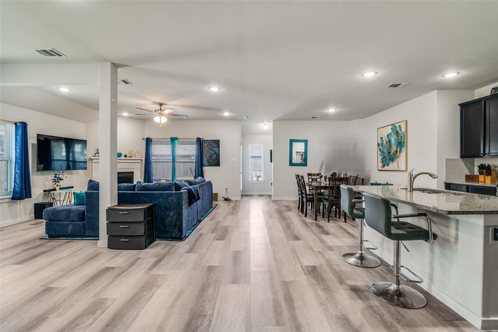 4204 Bullock Lane Forney, TX 75126 - Photo 7 of 25 a living room with furniture a wooden floor and a flat screen tv