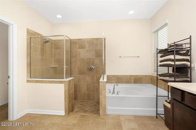 a bathroom with a bathtub and a shower