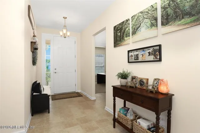 a view of a hallway with workspace and a window