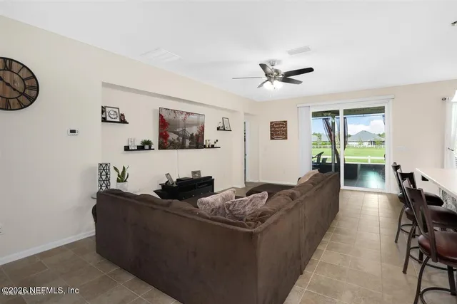 a living room with furniture and a ceiling fan