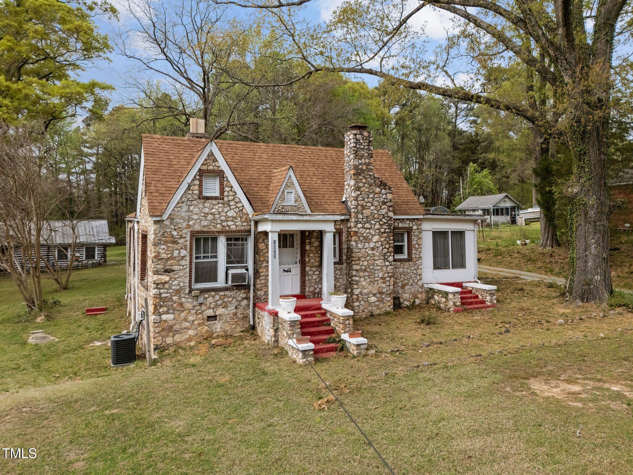 a view of a house with a yard porch and sitting area
