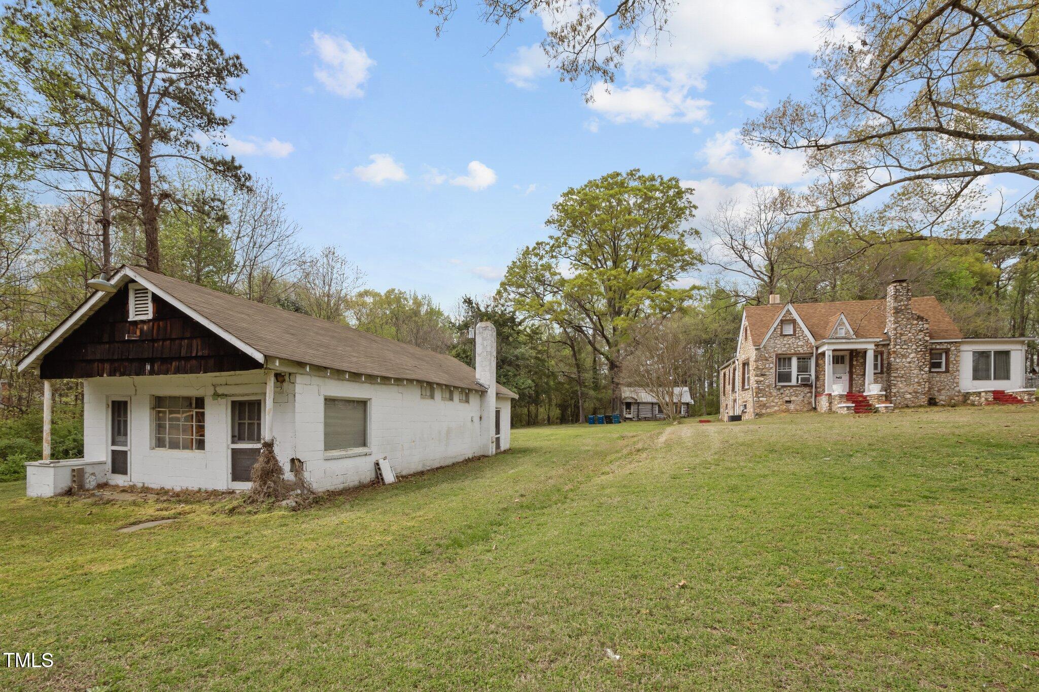 1823 East Geer Street Durham, NC 27704 - Photo 21 of 55 a view of a large house with a big yard and large trees