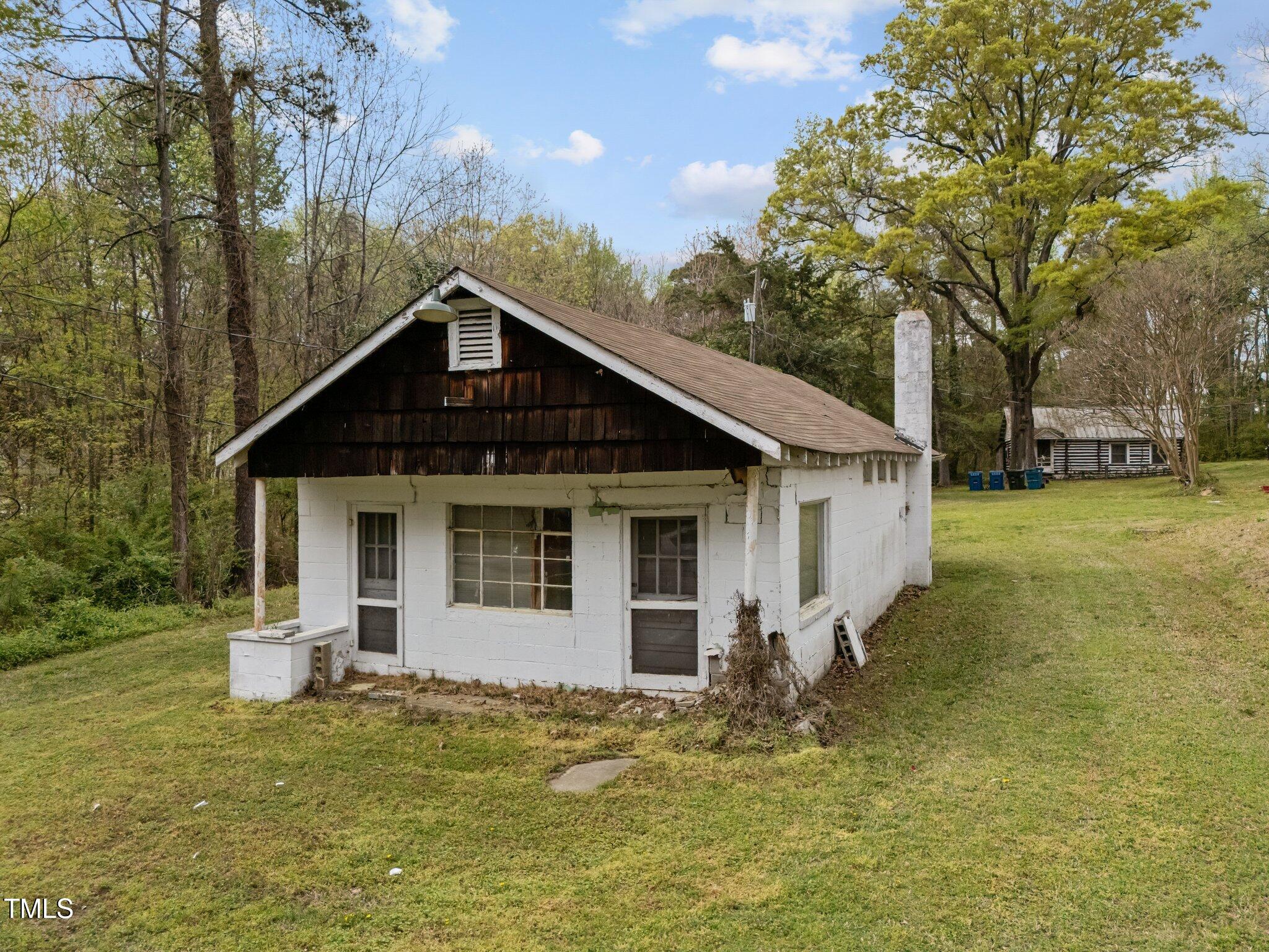 1823 East Geer Street Durham, NC 27704 - Photo 4 of 55 a front view of a house with a yard garage and outdoor seating