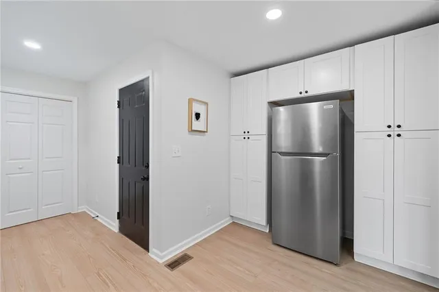 a metallic refrigerator freezer sitting in a kitchen