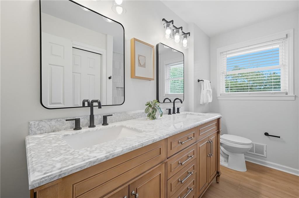 9 Chestnut Street Cartersville, GA 30120 - Photo 17 of 45 a bathroom with a granite countertop sink and a mirror